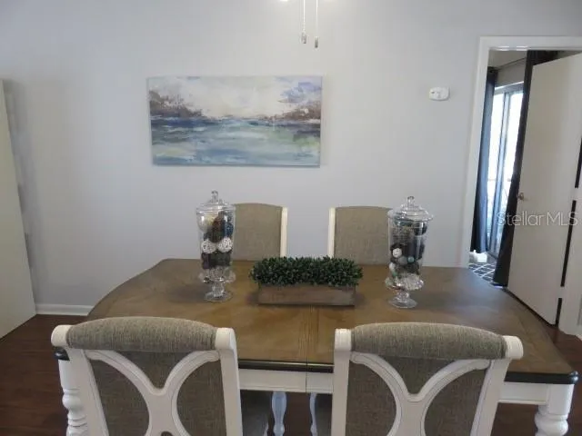 a dining room with furniture and wooden floor