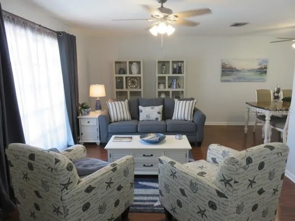 a living room with furniture and wooden floor