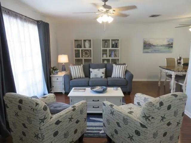 a living room with furniture and wooden floor