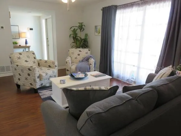 a living room with furniture and a potted plant