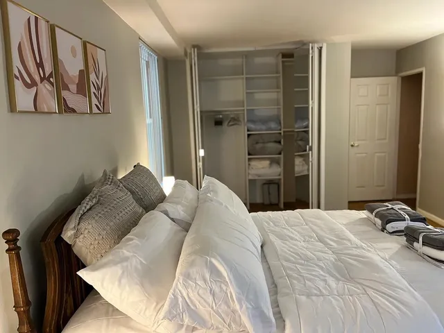 a bedroom with a bed and a painting on the wall