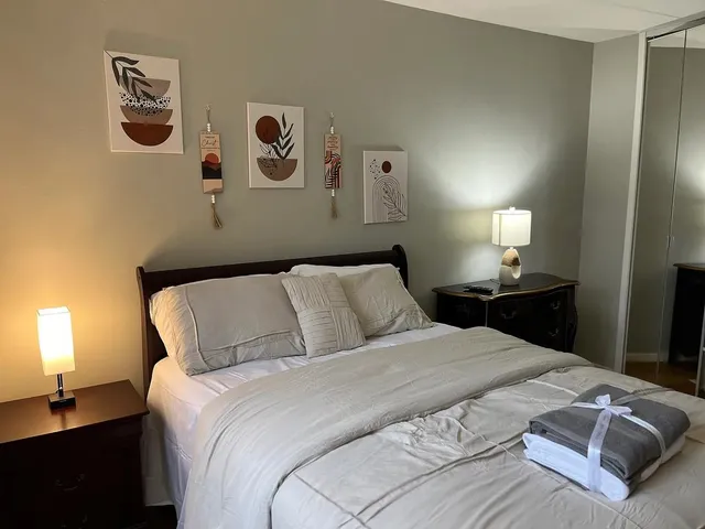 a bedroom with a bed and a lamp