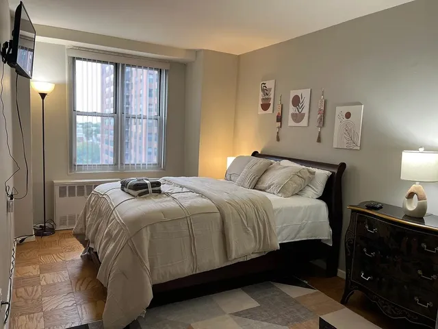 a bedroom with a bed and a window