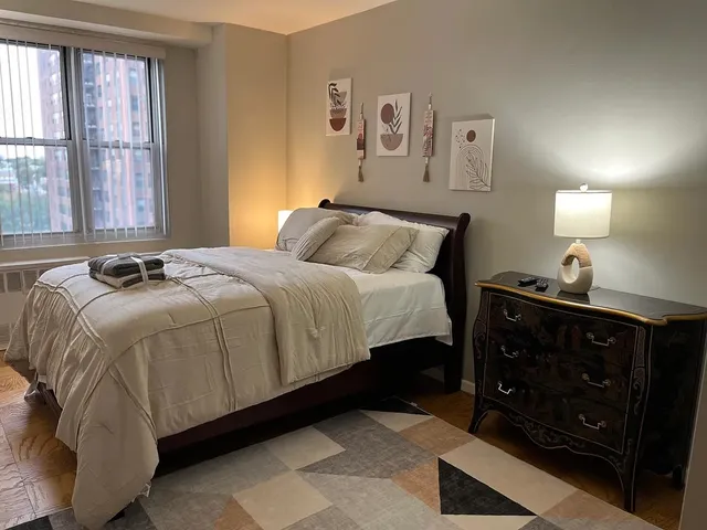 a bedroom with a bed and window