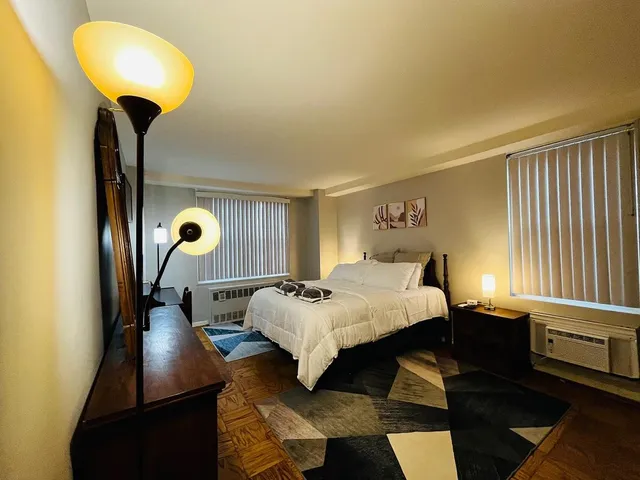 a bed room with a bed and a chandelier