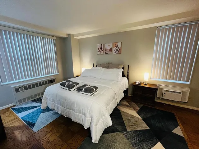 a living room with a bed furniture and a window