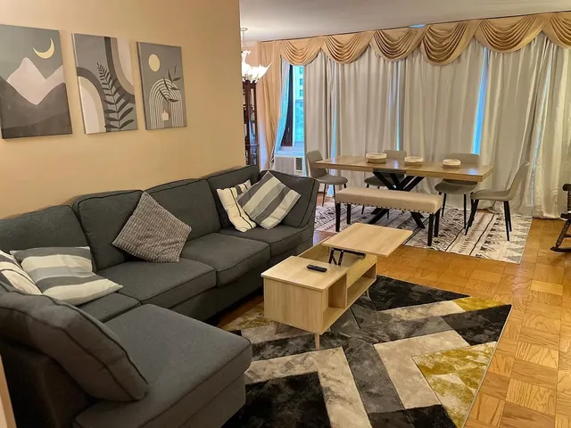 a living room with furniture and a lamp