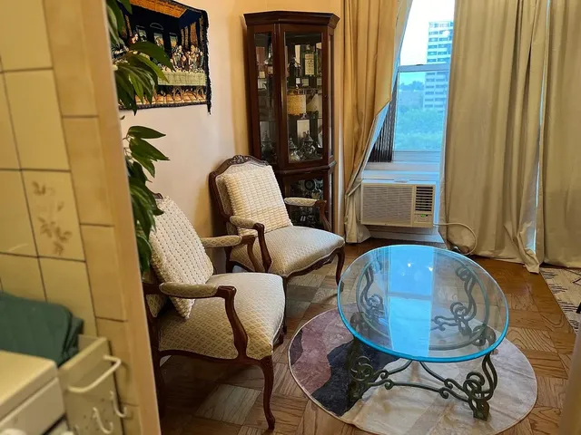 a view of a room with furniture and wooden floor