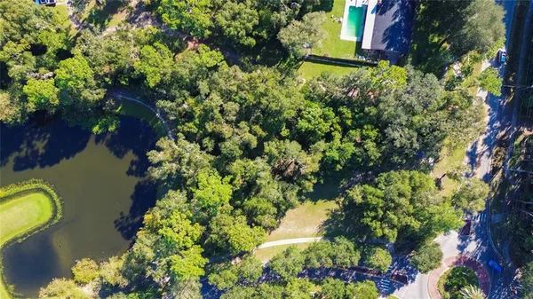 an aerial view of a house with a yard and garden