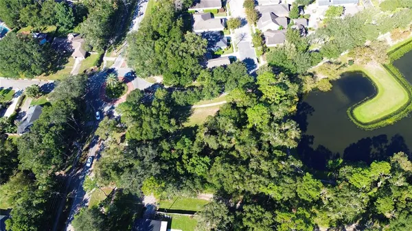 an aerial view of a house with a yard and garden