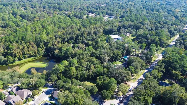 a view of a house with a yard and swimming pool