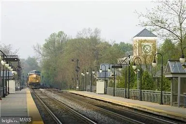 a view of a dining hall with stainless steel appliances granite countertop a stove and a refrigerator