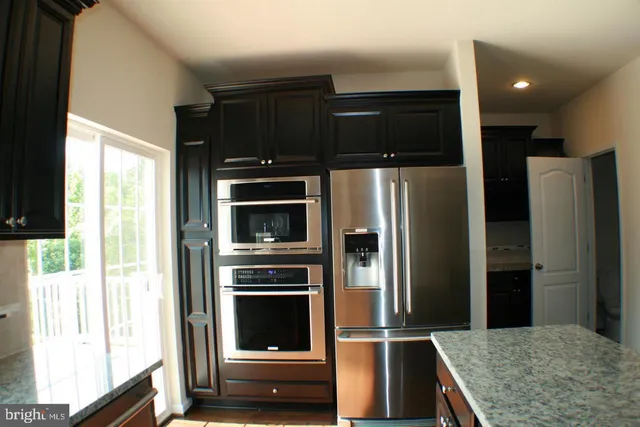 a kitchen with a refrigerator stove and microwave