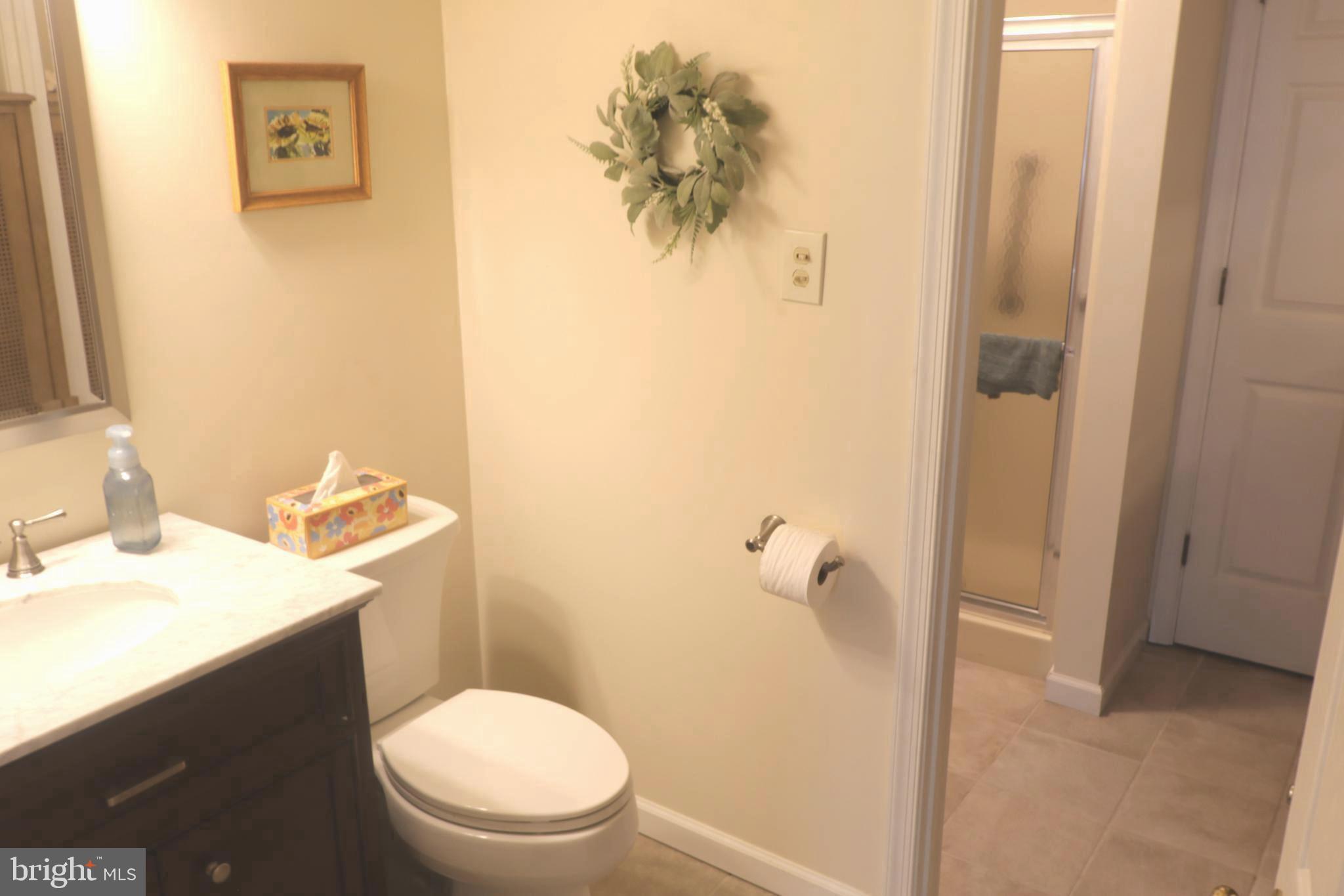 118 Primrose Lane Reading, PA 19610 - Photo 21 of 36 a white toilet sitting next to a bathroom sink and vanity