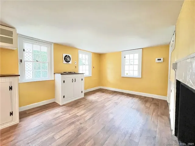 a view of a kitchen with wooden floor and a window
