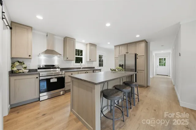 a kitchen with granite countertop a stove and a refrigerator
