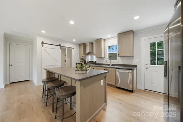 a kitchen with a sink cabinets and wooden floor
