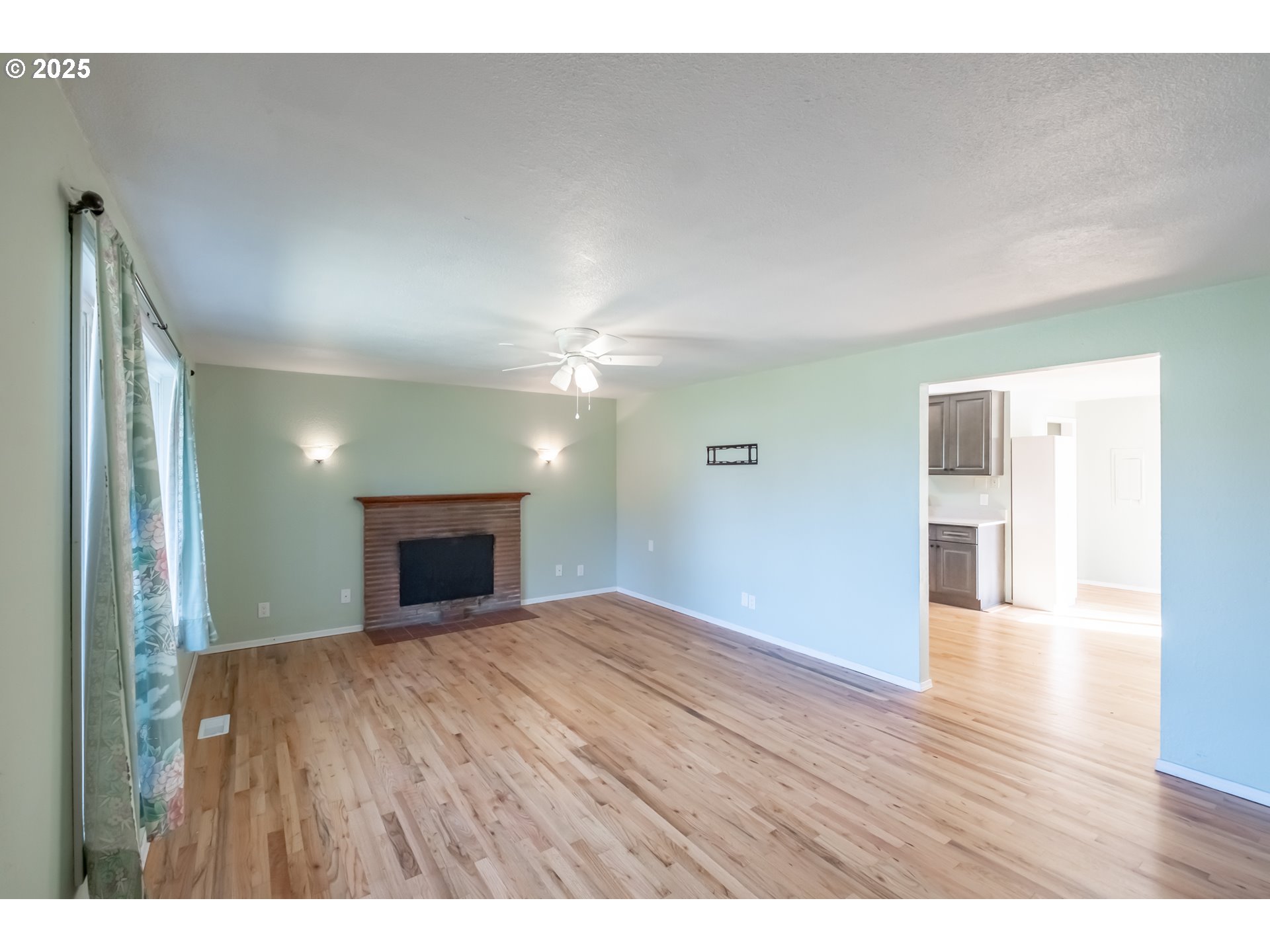 1625 Southeast Jackson Street Albany, OR 97322 - Photo 7 of 38 a view of an empty room with wooden floor fireplace and a window