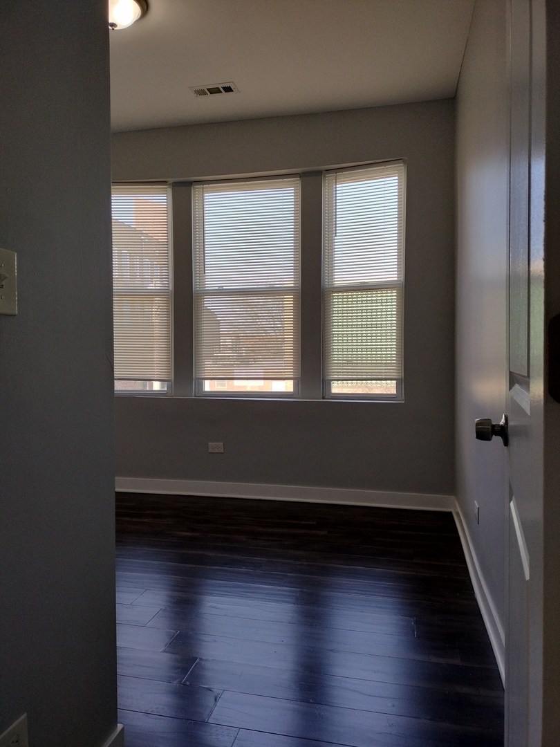 1945 West 48th Street, Unit 2 Chicago, IL 60609 - Photo 4 of 19 a view of a room with wooden floors and a window