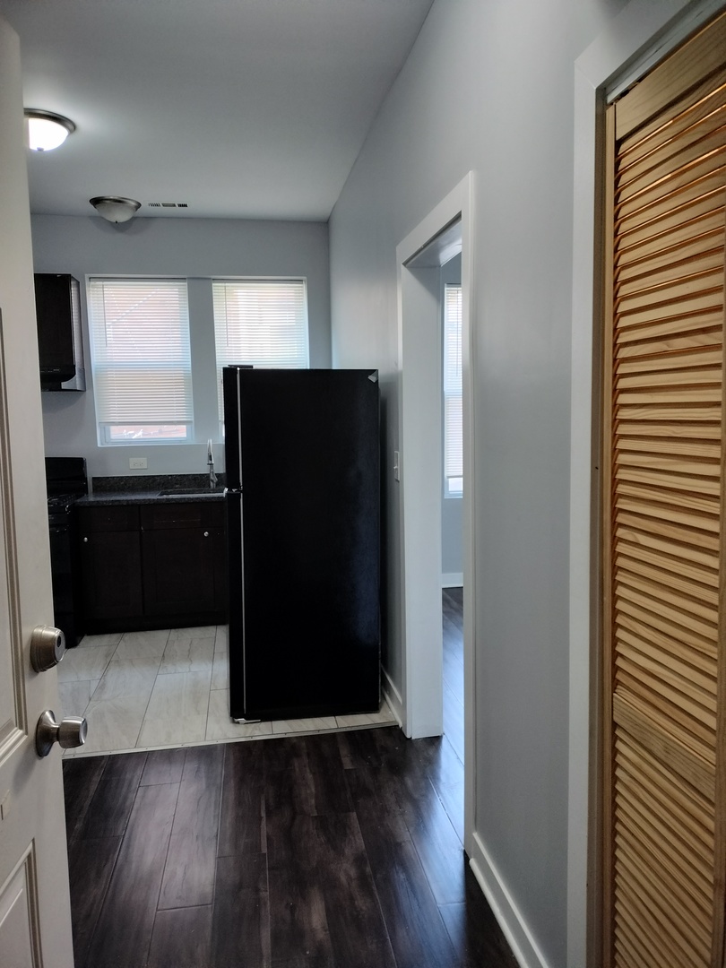 1945 West 48th Street, Unit 2 Chicago, IL 60609 - Photo 5 of 19 wooden floor in an empty room with a window