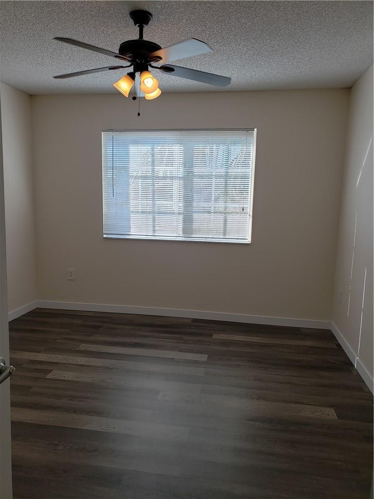 7930 North Nob Hill Road, Unit 3305 Tamarac, FL 33321 - Photo 11 of 28 a view of an empty room with wooden floor and a window