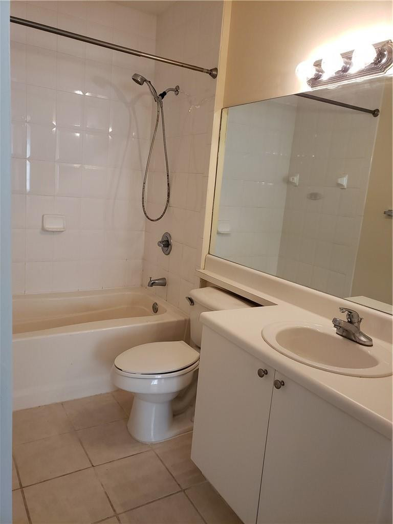 7930 North Nob Hill Road, Unit 3305 Tamarac, FL 33321 - Photo 13 of 28 a bathroom with a granite countertop sink a toilet and a mirror