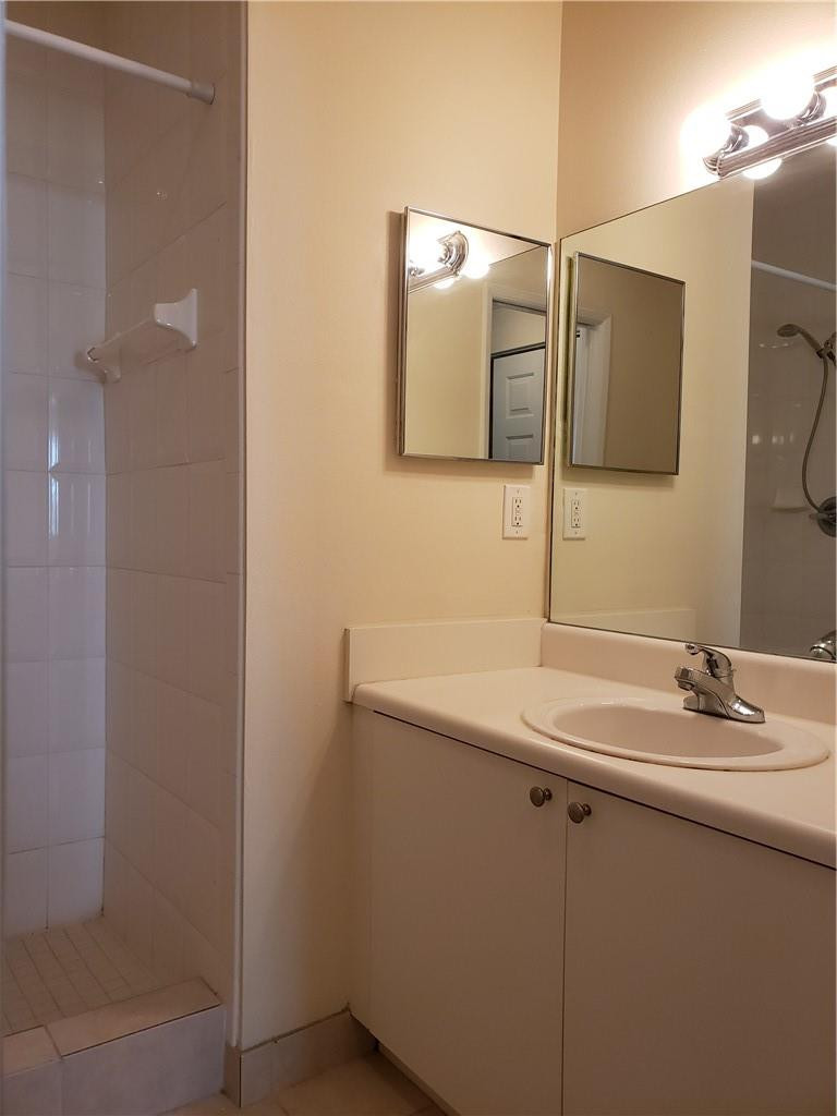 7930 North Nob Hill Road, Unit 3305 Tamarac, FL 33321 - Photo 15 of 28 a bathroom with a sink and a mirror