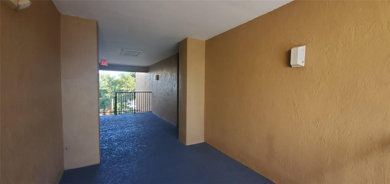 7930 North Nob Hill Road, Unit 3305 Tamarac, FL 33321 - Photo 17 of 28 a view of a hallway with wooden floor and a window