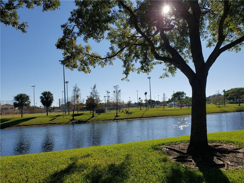 7930 North Nob Hill Road, Unit 3305 Tamarac, FL 33321 - Photo 19 of 28 a view of a lake with houses