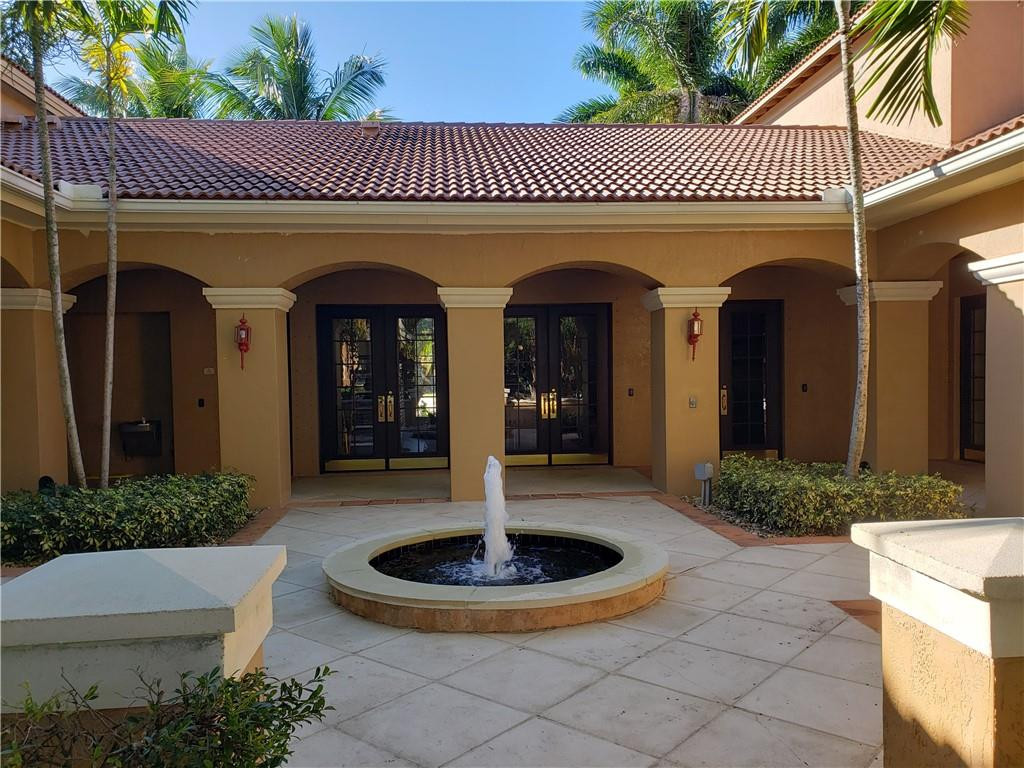 7930 North Nob Hill Road, Unit 3305 Tamarac, FL 33321 - Photo 21 of 28 a front view of a house with garden