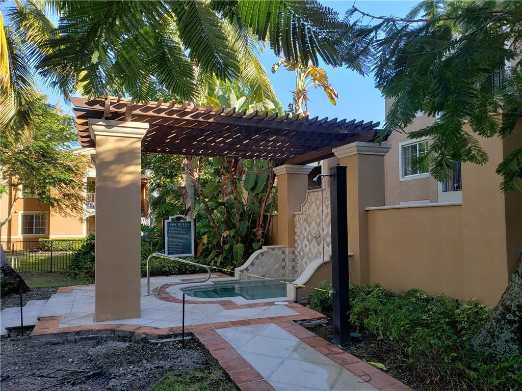 7930 North Nob Hill Road, Unit 3305 Tamarac, FL 33321 - Photo 23 of 28 a front view of a house with garden