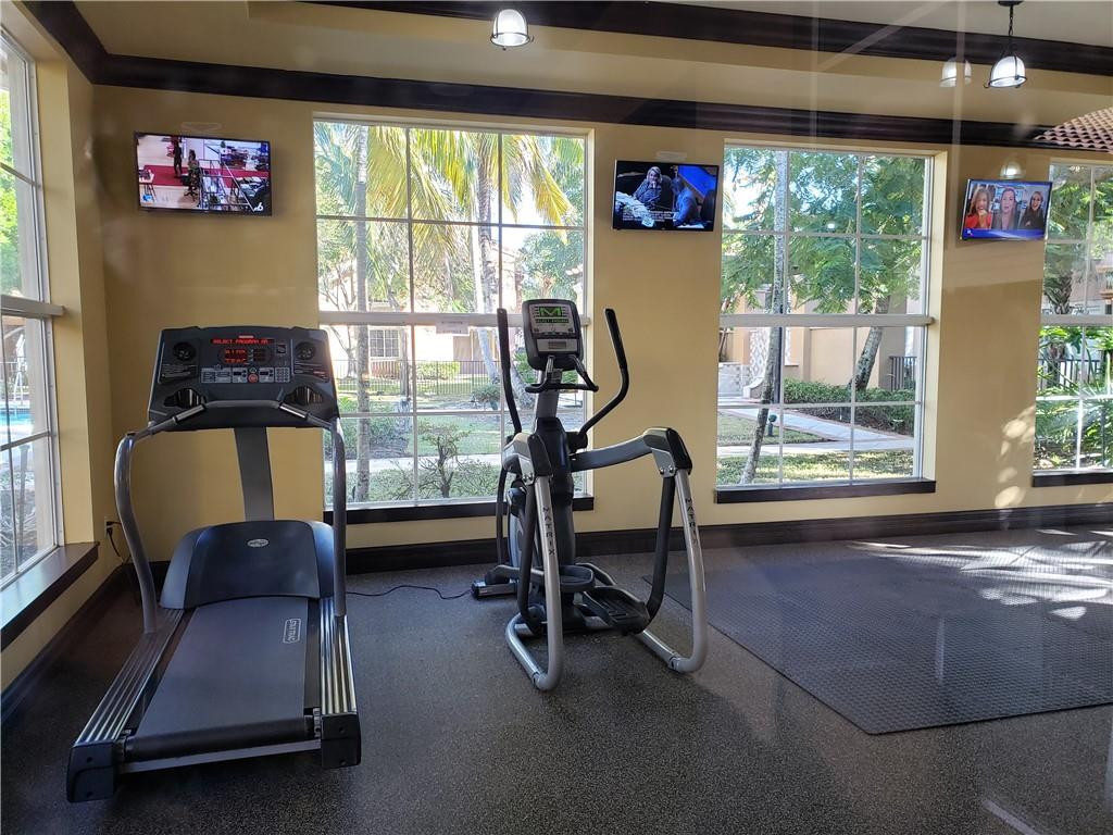 7930 North Nob Hill Road, Unit 3305 Tamarac, FL 33321 - Photo 24 of 28 a view of a room with gym equipment and a large window