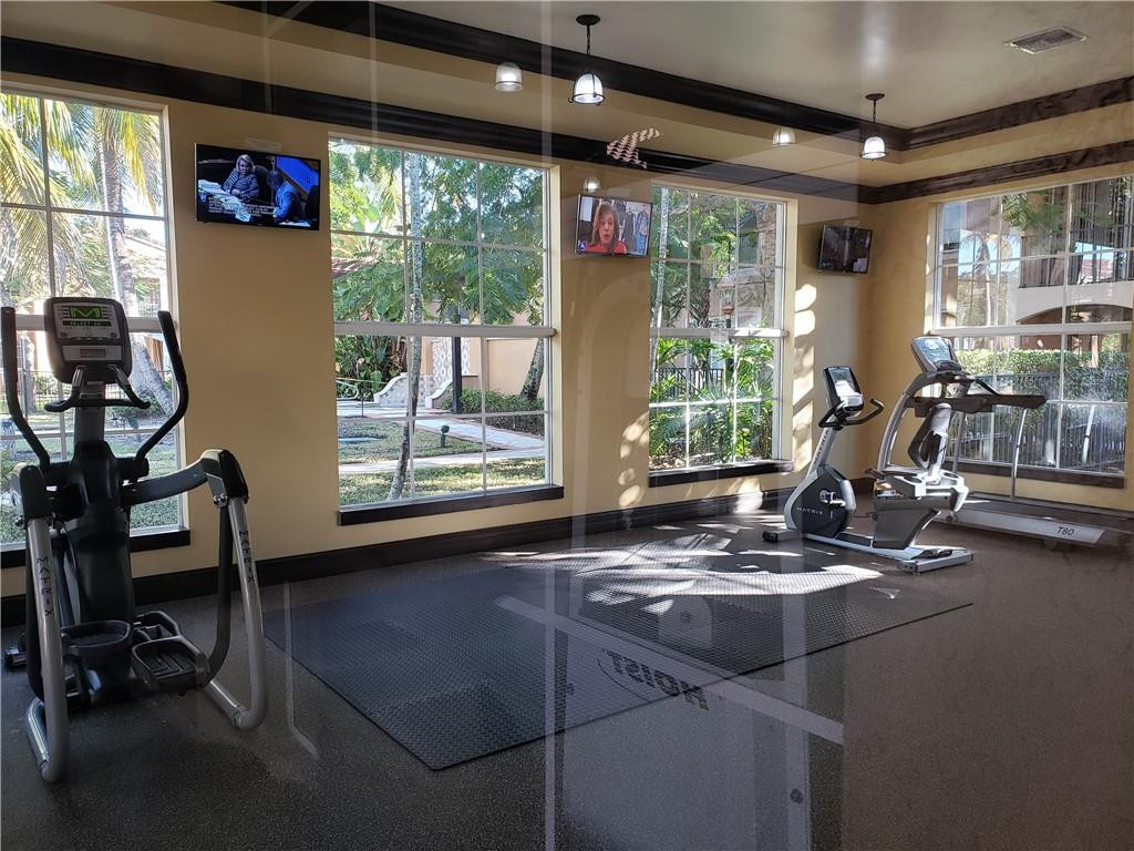 7930 North Nob Hill Road, Unit 3305 Tamarac, FL 33321 - Photo 25 of 28 a room with gym equipment and a large window