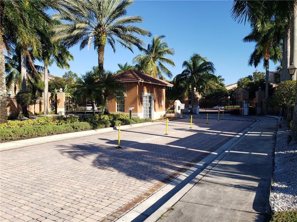 7930 North Nob Hill Road, Unit 3305 Tamarac, FL 33321 - Photo 27 of 28 a tennis court with palm trees