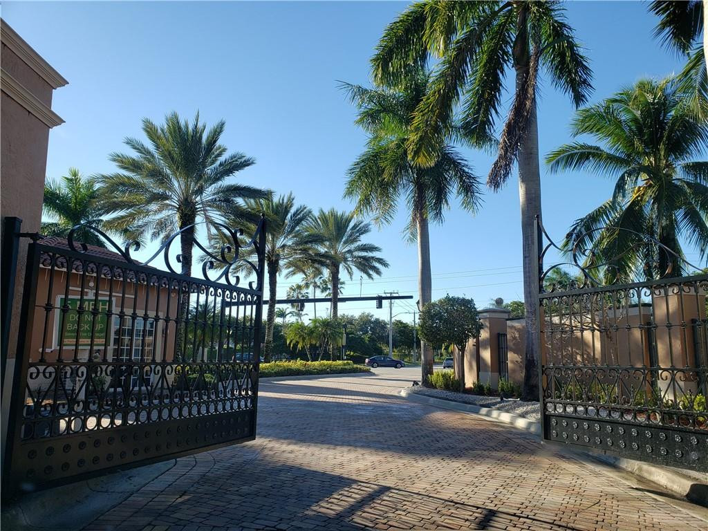 7930 North Nob Hill Road, Unit 3305 Tamarac, FL 33321 - Photo 28 of 28 a view of a palm trees front of a house with a street