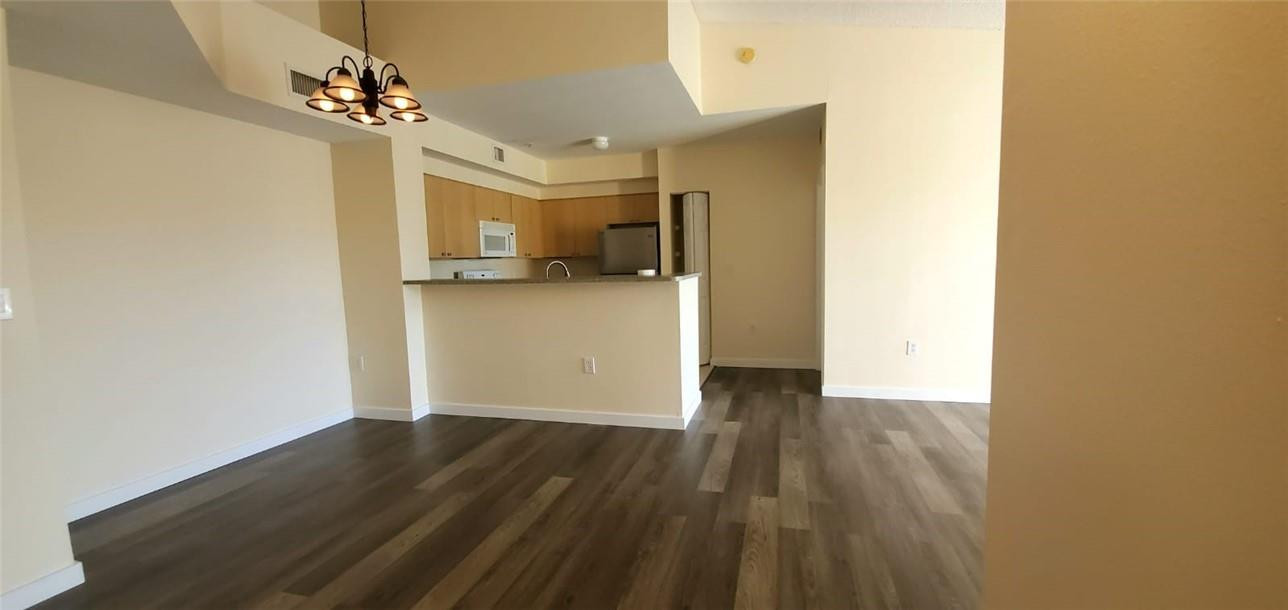 7930 North Nob Hill Road, Unit 3305 Tamarac, FL 33321 - Photo 5 of 28 a view of a kitchen from a hallway