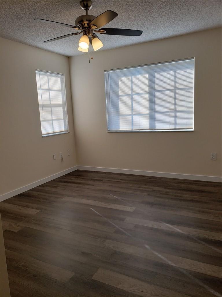 7930 North Nob Hill Road, Unit 3305 Tamarac, FL 33321 - Photo 10 of 28 a view of an empty room with wooden floor and a window
