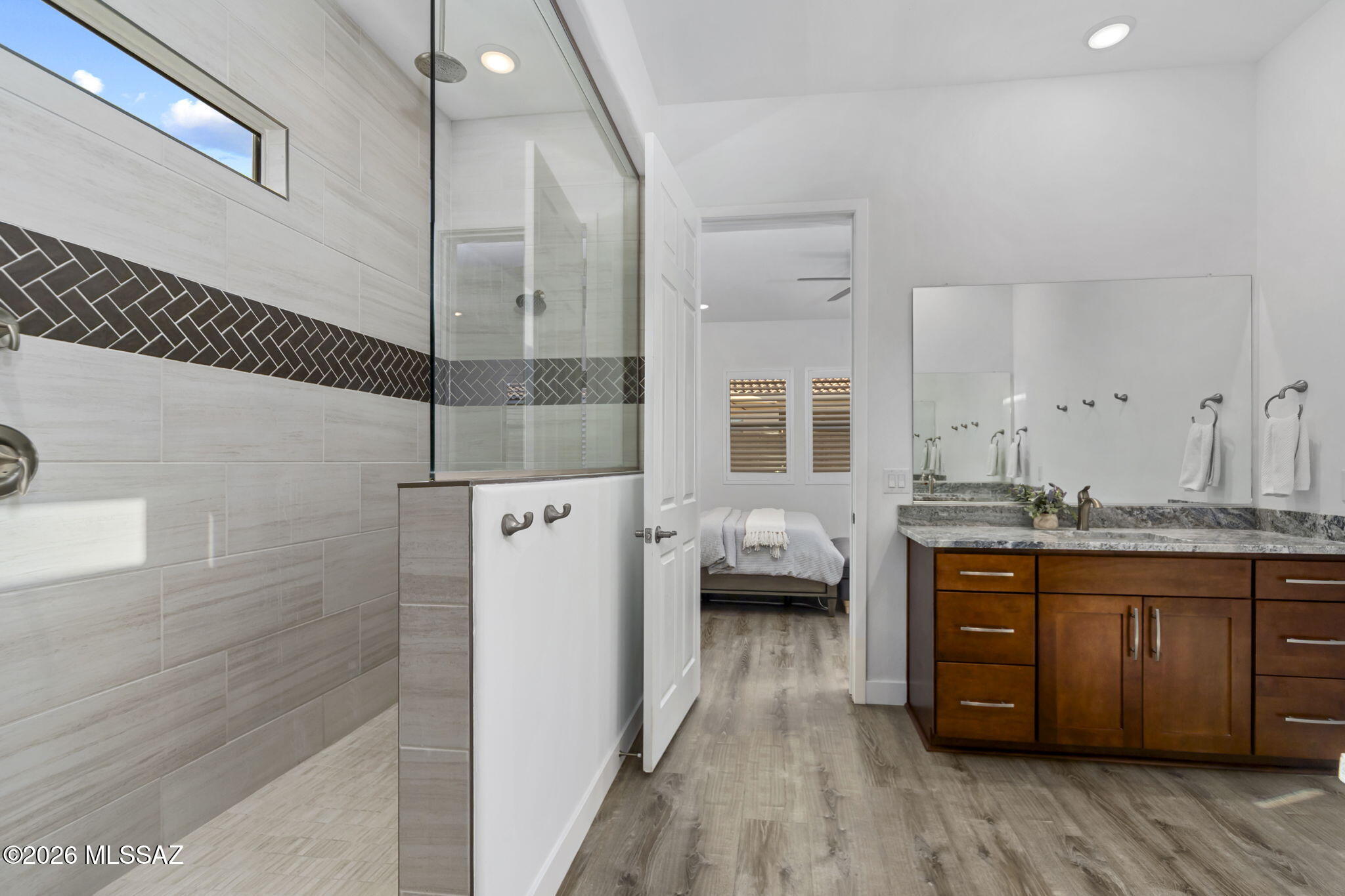 12791 East Tortoise Pointe Drive Vail, AZ 85641 - Photo 27 of 50 a en suite bathroom with a tub mirror and sink