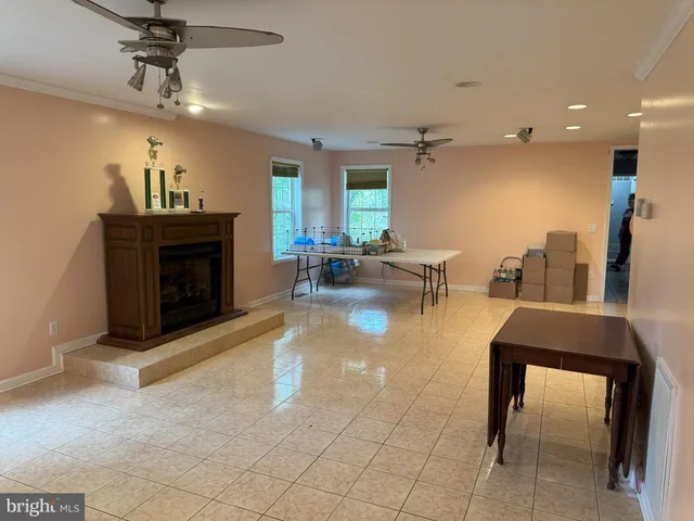 a living room with furniture a fireplace and a chandelier