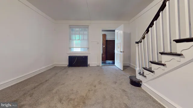 an empty room with fireplace and windows