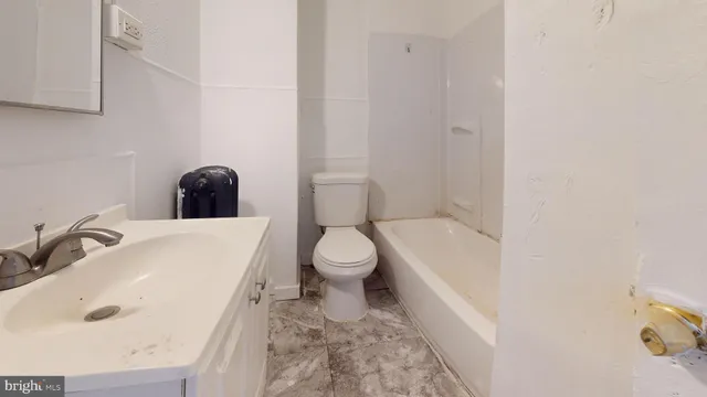 a bathroom with a toilet and a sink