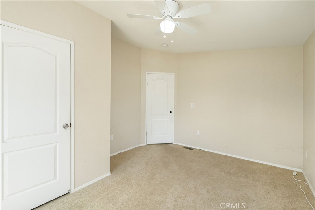 5800 Hamner Avenue, Unit 156 Eastvale, CA 91752 - Photo 12 of 20 an empty room with a chandelier fan and closet