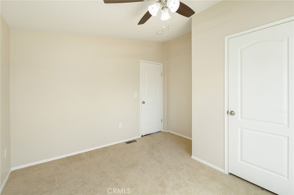 5800 Hamner Avenue, Unit 156 Eastvale, CA 91752 - Photo 13 of 20 an empty room with a chandelier fan