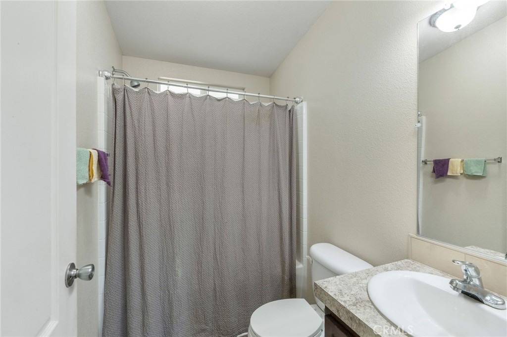 5800 Hamner Avenue, Unit 156 Eastvale, CA 91752 - Photo 15 of 20 a bathroom with a granite countertop sink toilet and shower