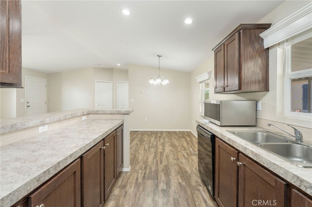 5800 Hamner Avenue, Unit 156 Eastvale, CA 91752 - Photo 4 of 20 a kitchen with a sink granite counter tops and a stove