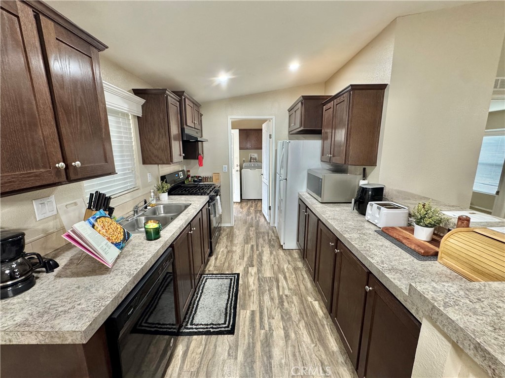 5800 Hamner Avenue, Unit 156 Eastvale, CA 91752 - Photo 5 of 20 a kitchen with stainless steel appliances granite countertop a sink stove and refrigerator