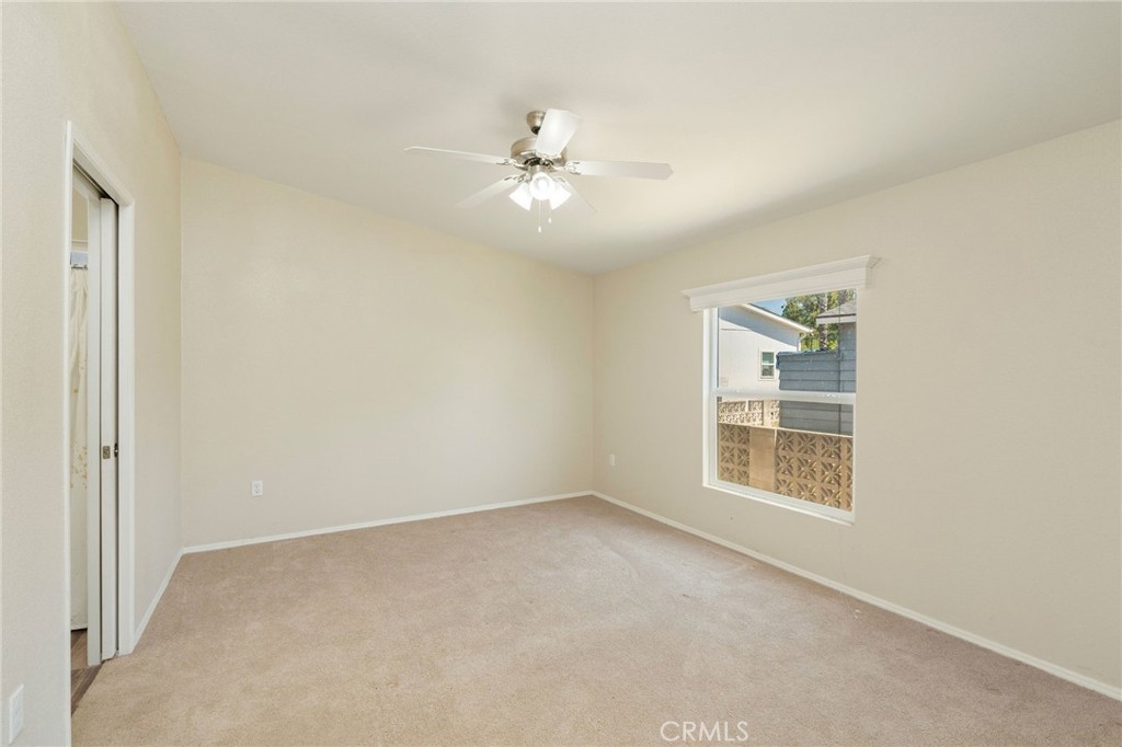 5800 Hamner Avenue, Unit 156 Eastvale, CA 91752 - Photo 9 of 20 an empty room with windows and fan