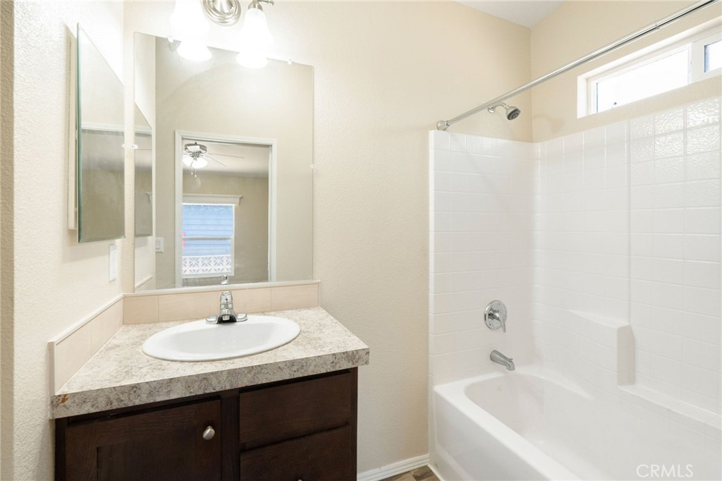 5800 Hamner Avenue, Unit 156 Eastvale, CA 91752 - Photo 10 of 20 a bathroom with a granite countertop sink and a mirror