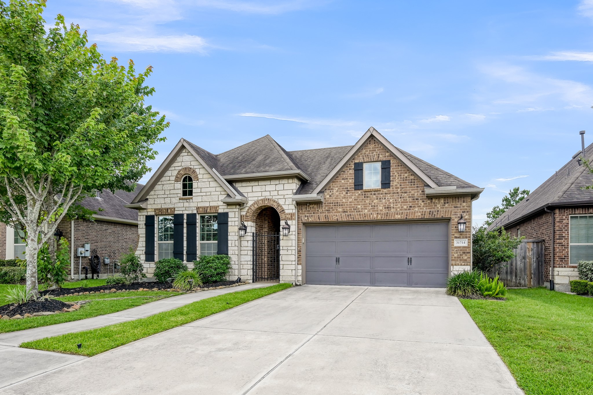 31714 Pierwood Court Spring, TX 77386 - Photo 2 of 49 a front view of a house with a yard and garage