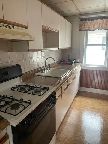 a kitchen with a stove and a sink
